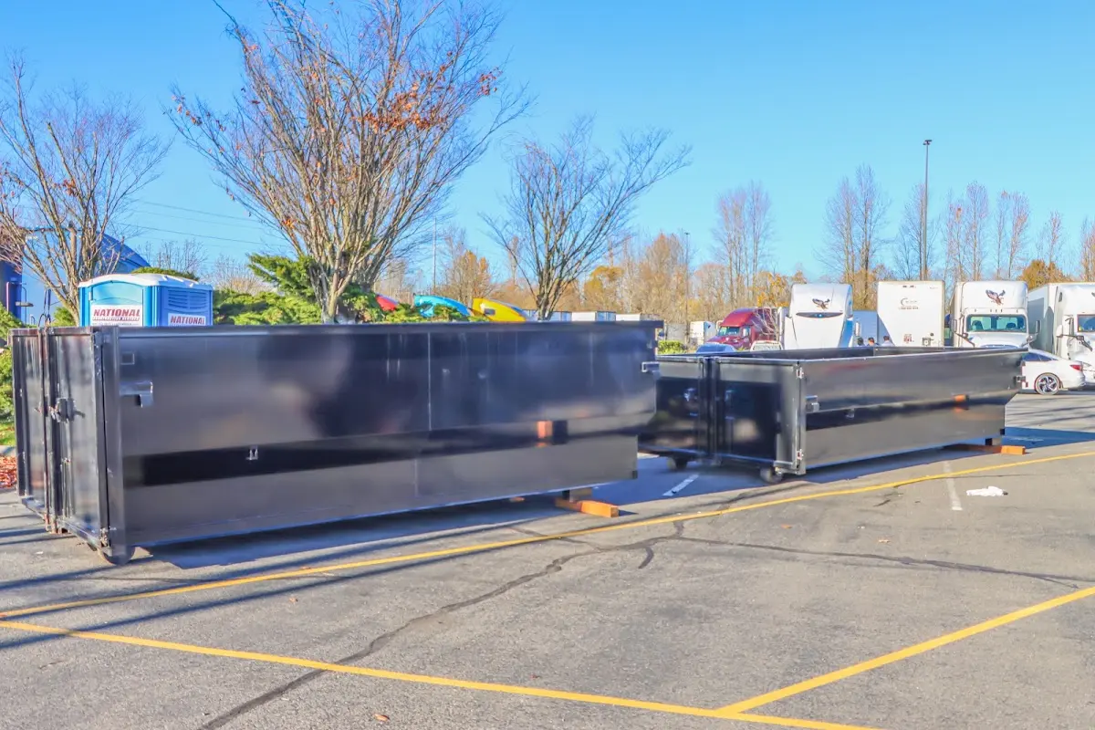 Professional dumpster rental service with roll-off container on residential driveway in Lansdale